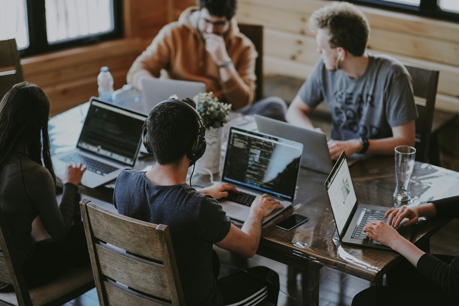 A software team working side by side around a shared table